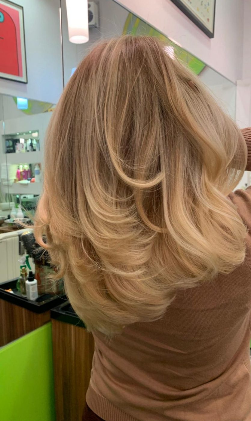 Long honey blonde layers, finished in the salon