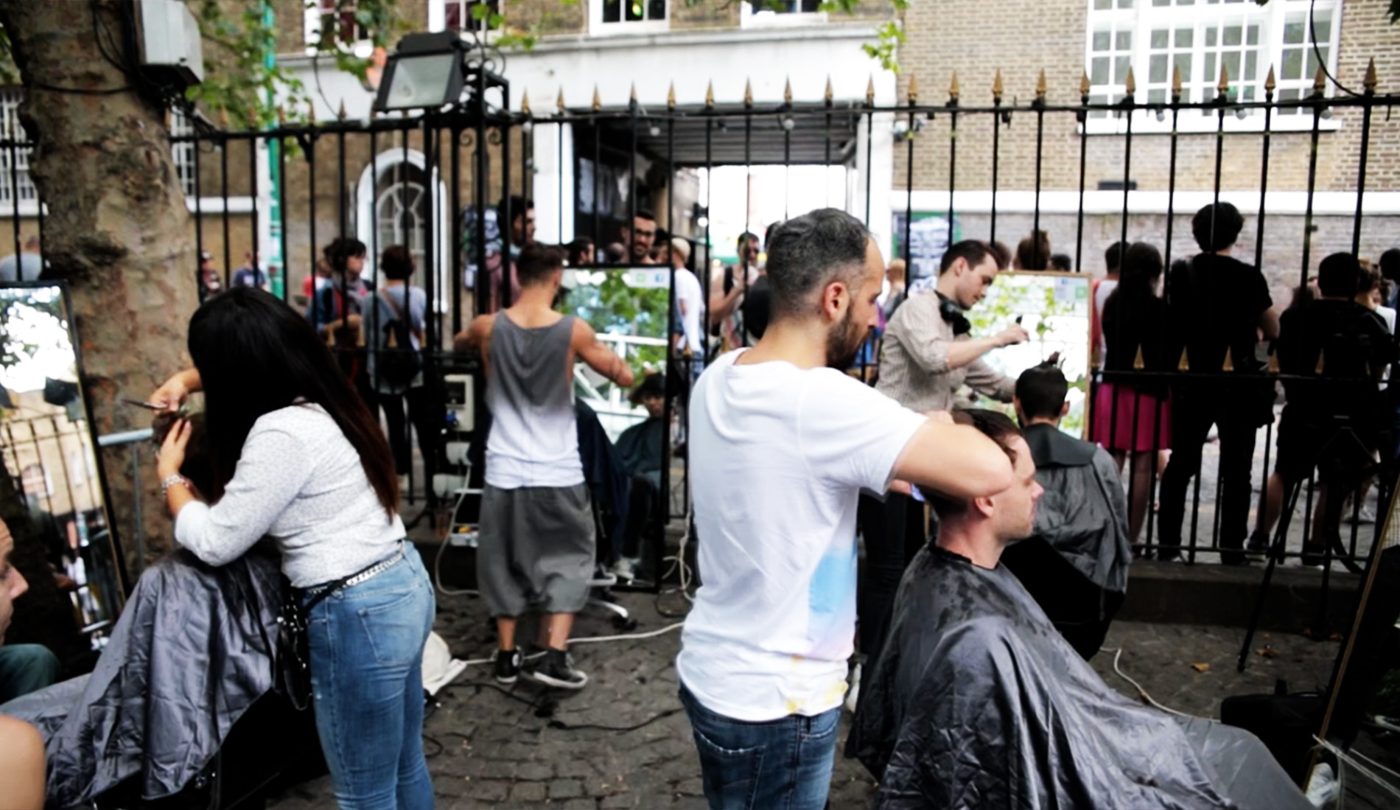 Hairdressers cutting hair outdoors at Vibe Cuts, Brick Lane